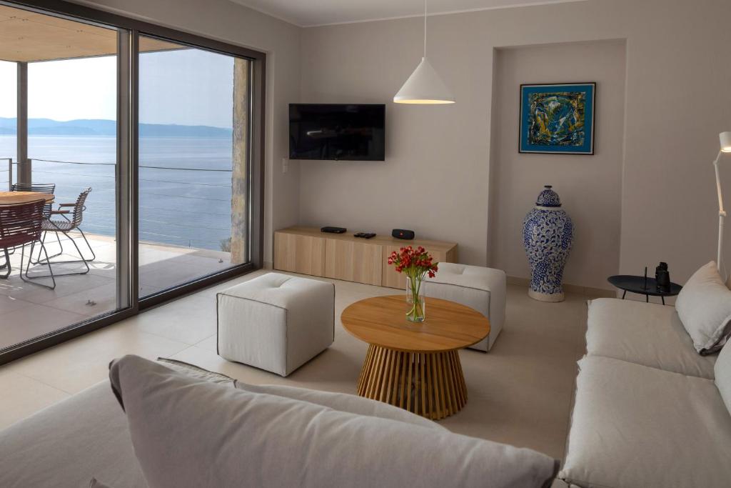 a living room with a couch and a table at Kechria Bay Villas in Skiathos