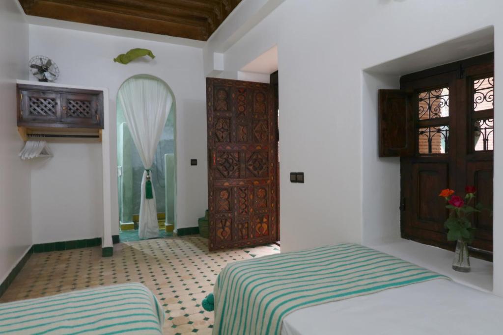 Postel nebo postele na pokoji v ubytování Riad Dada Mouss & Suites