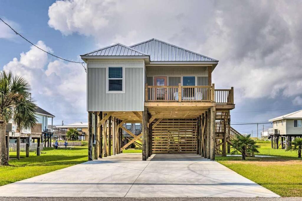 a house on wooden posts with a porch at Newly Built DAUPHIN ISLAND Home! in Dauphin Island
