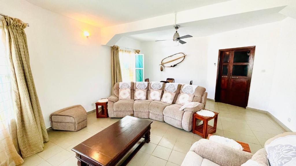 a living room with a couch and a table at Ya Aluga Apartment - Serekunda in Serekunda