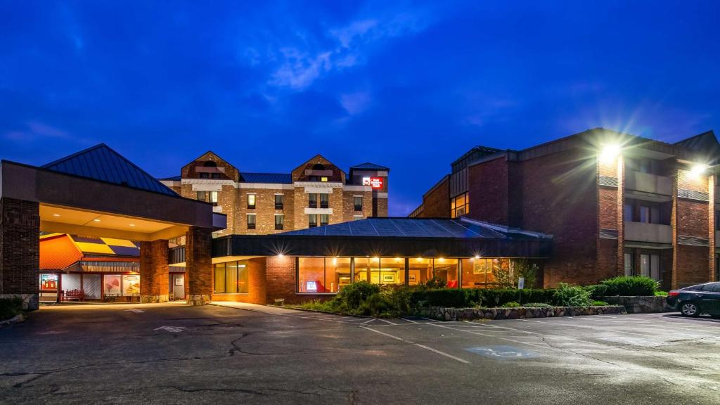 a parking lot in front of a hotel at night at Best Western Plus Portsmouth Hotel & Suites in Portsmouth
