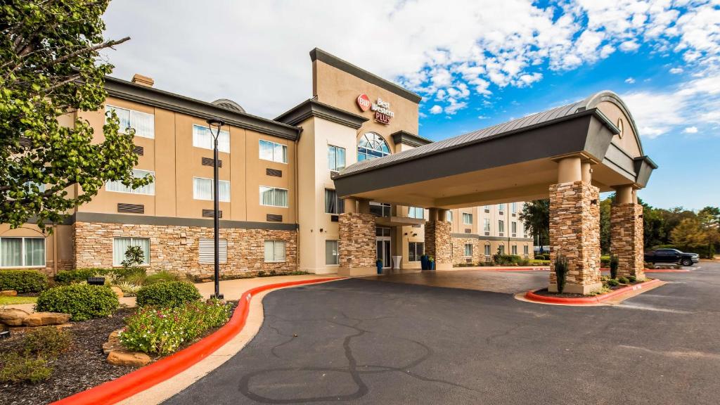 a hotel building with a parking lot at Best Western Plus Longview – University Hotel in Longview