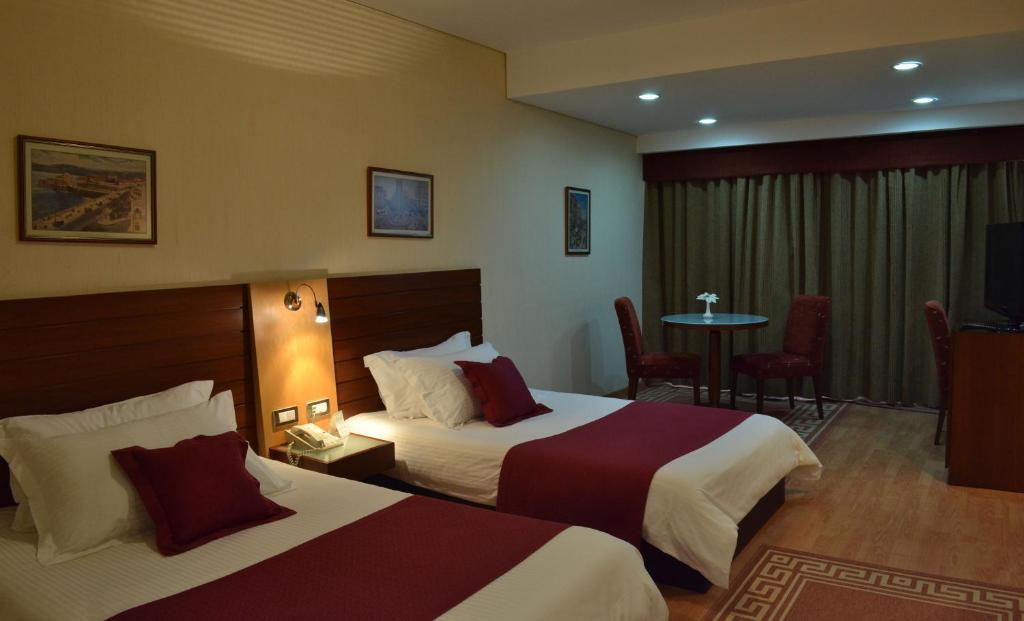 Postel nebo postele na pokoji v ubytování Monteverde Hotel