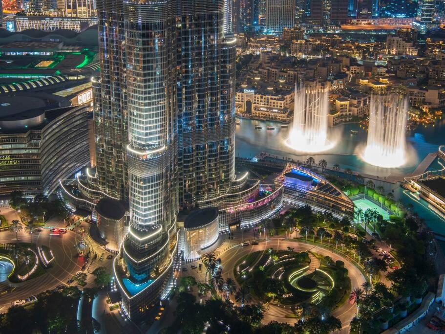 an aerial view of a city at night at FIRST CLASS 3BR with full BURJ KHALIFA and FOUNTAIN VIEW in Dubai