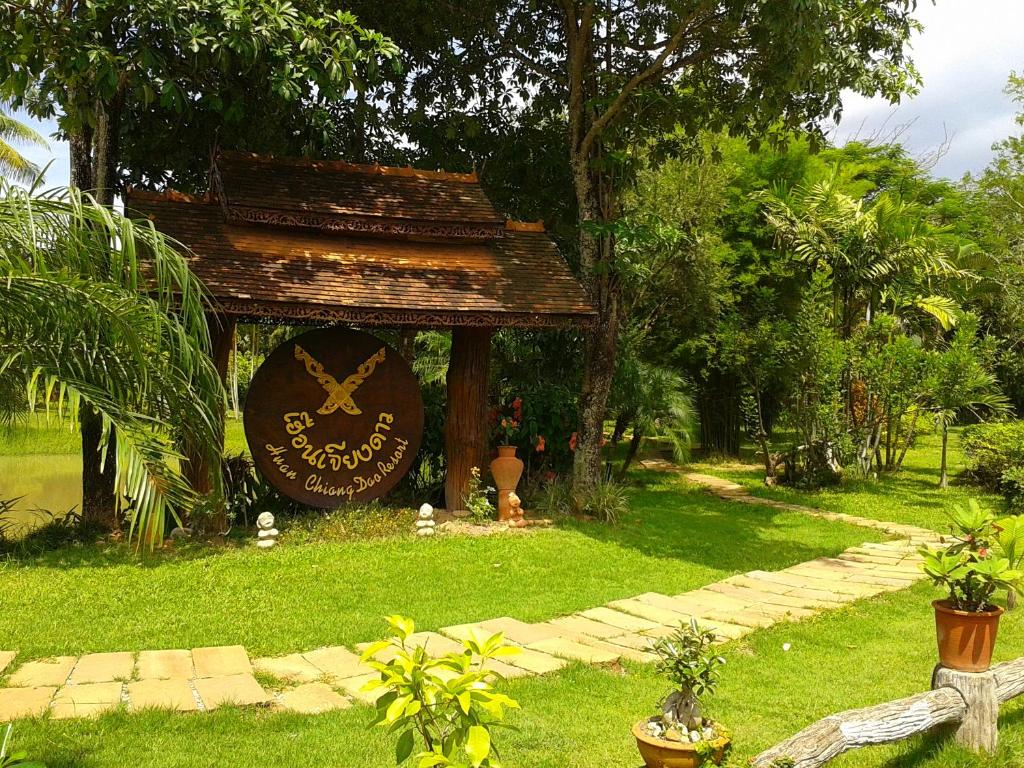 a gazebo with a sign in the grass at Huan Chiang Dao Resort in Chiang Dao