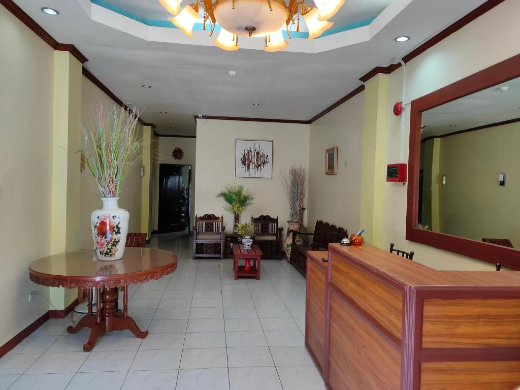 a lobby with a waiting room with a table at Fiesta Ballroom Hotel in Legazpi