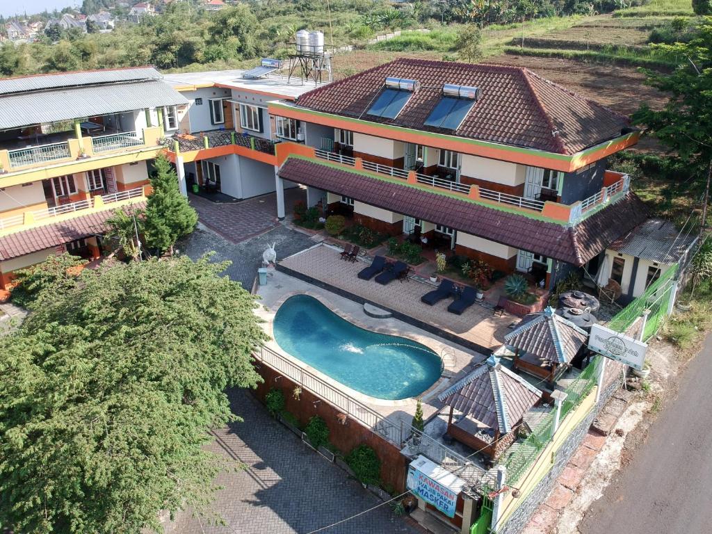 an aerial view of a house with a swimming pool at Villa Panderman Indah in Batu