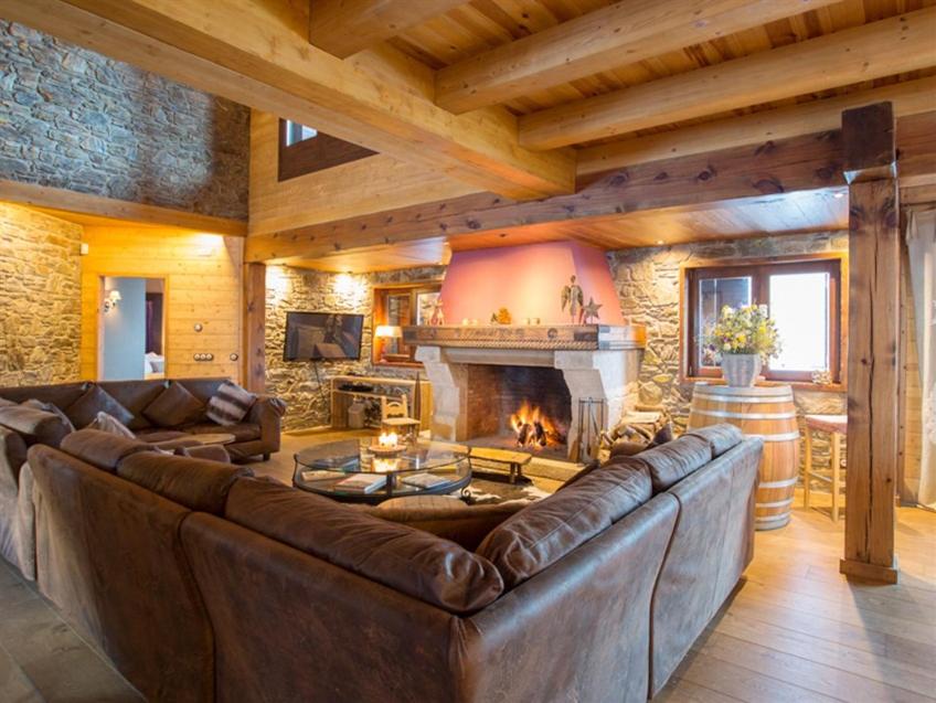 a living room with a couch and a fireplace at Borda del Pi in Canillo