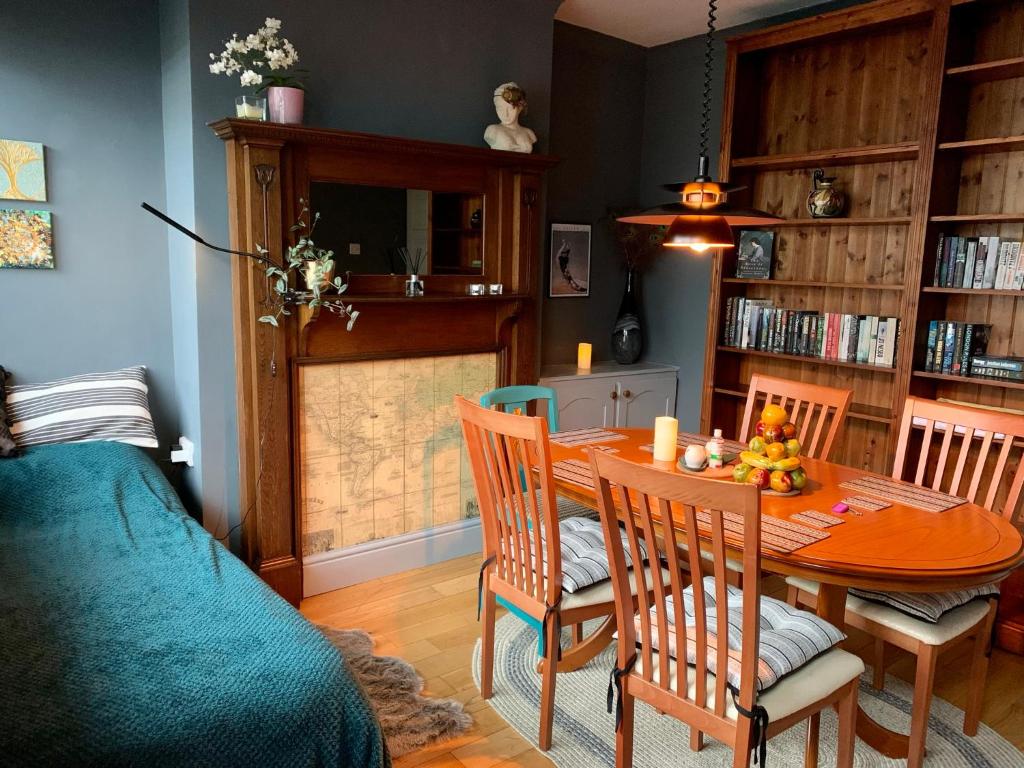 een eetkamer met een tafel en stoelen en een bed bij Character Cottage With Secluded Courtyard Garden in Chesterfield