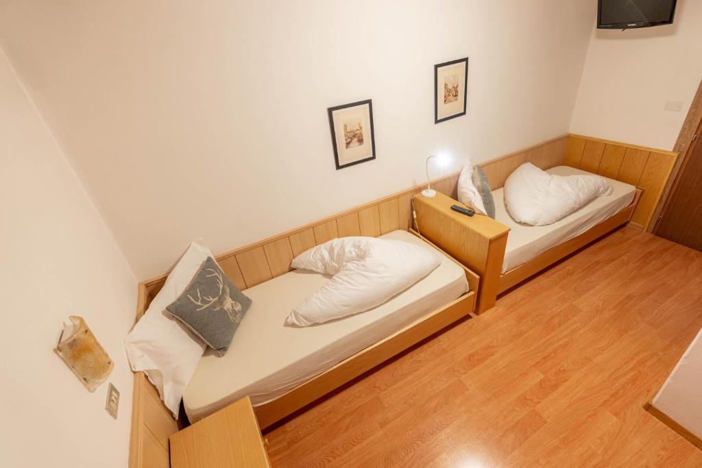 Postel nebo postele na pokoji v ubytování Albergo Dolomiti