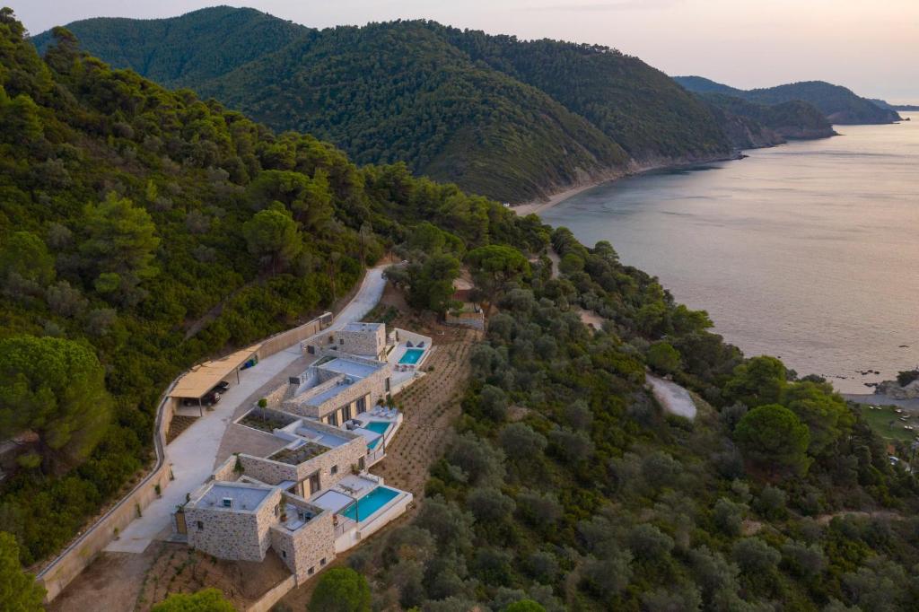 an aerial view of a house on a hill next to a river at Kechria Bay Villas in Skiathos