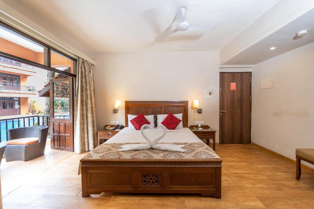 Postel nebo postele na pokoji v ubytování Neelam's The Grand Hotel Goa