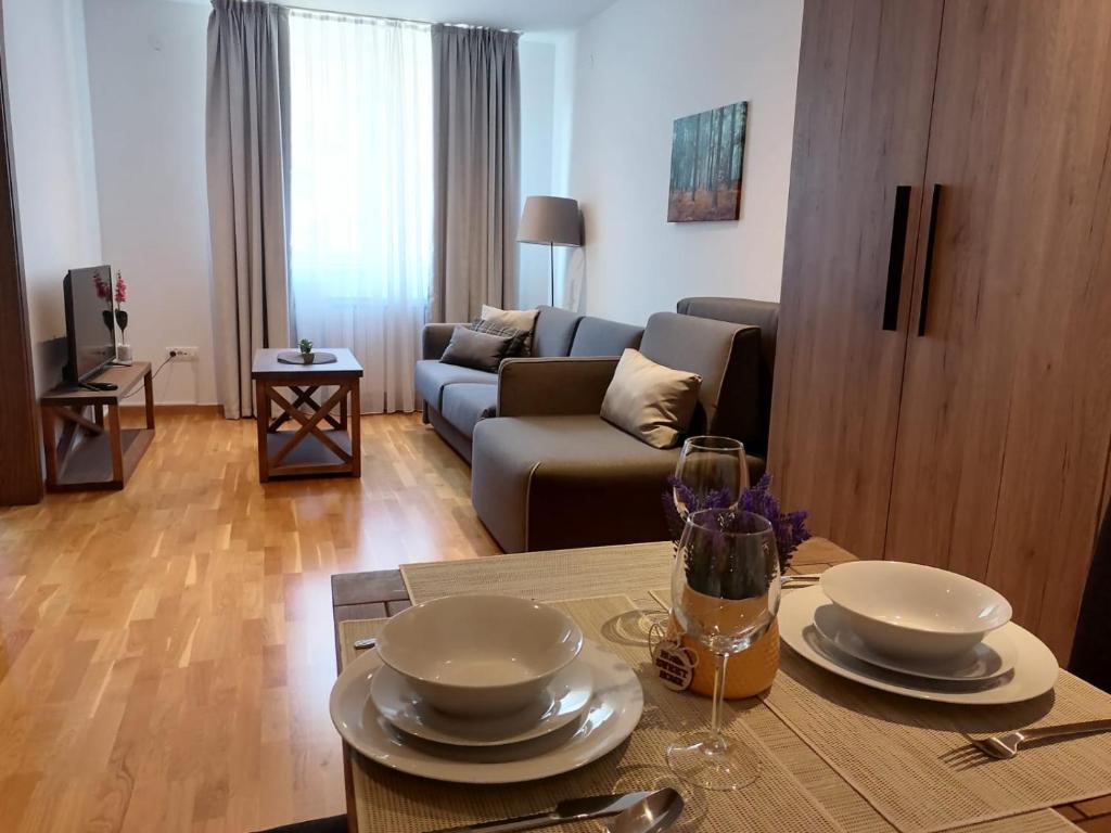 a living room with a table and a couch at Bela Jela - Brzeće, Kopaonik in Brzeće