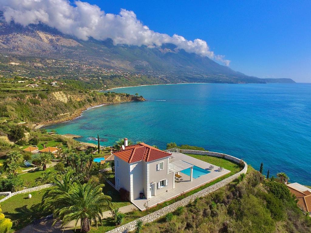 an aerial view of a house and the ocean at Seafront Villa Kefaloniaprivatevillas in Trapezaki
