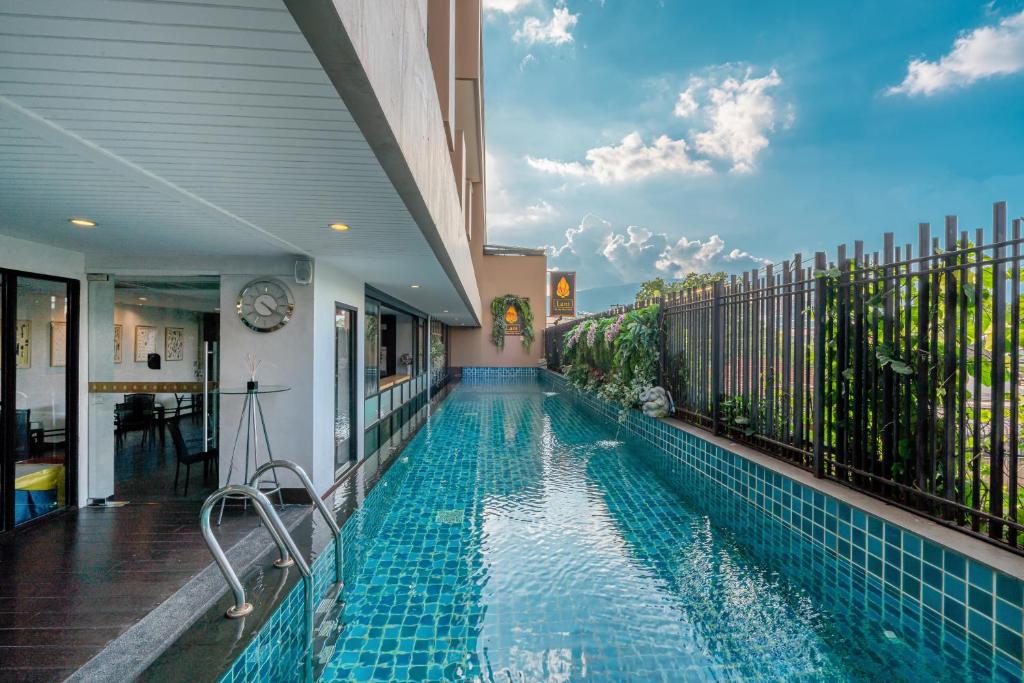a swimming pool in the backyard of a house at Lani Chiang Mai Hotel in Chiang Mai