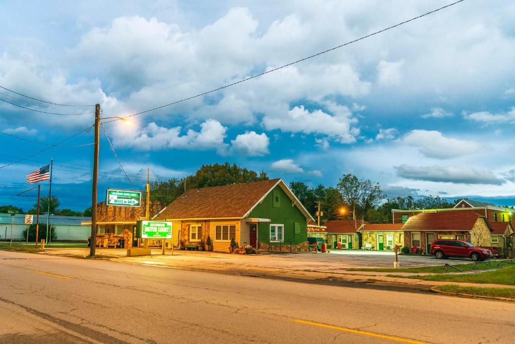 an empty street in a small town with houses at Rockwood Motor Court in Springfield