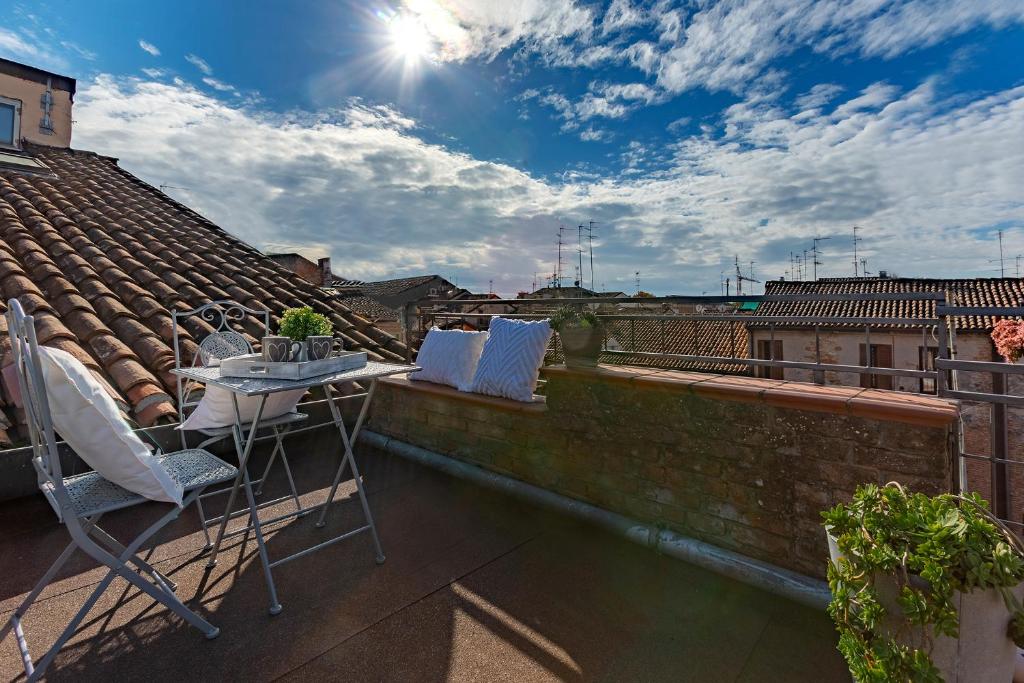 balcón con mesa y sillas en el techo en Ferrara Duplex Terrace Apartment x4, en Ferrara