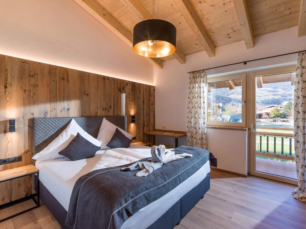 a bedroom with a bed and a large window at Baderer Apart in Stumm
