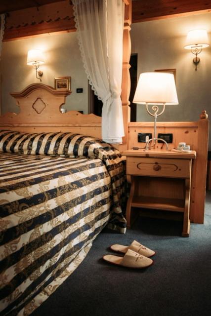 Postel nebo postele na pokoji v ubytování Hotel Primiero
