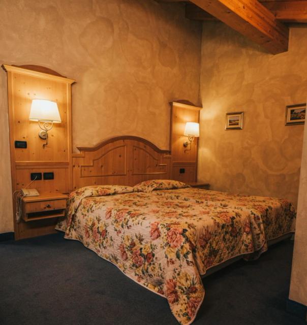 Postel nebo postele na pokoji v ubytování Hotel Primiero