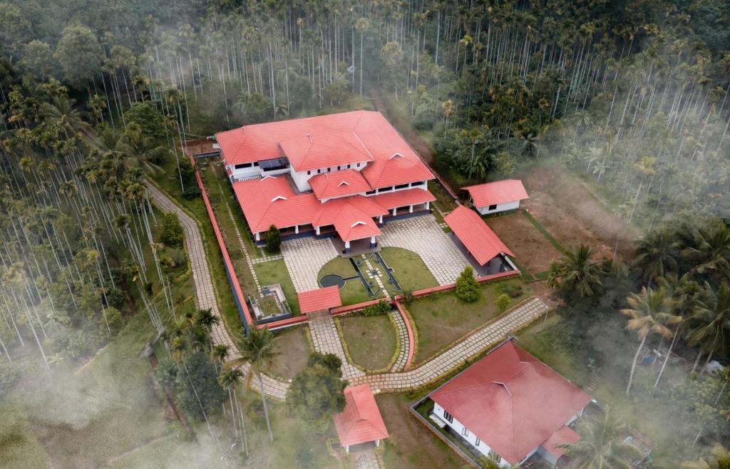 an aerial view of a house with red roofs at Wayanad Mace Mansion in Kenichira