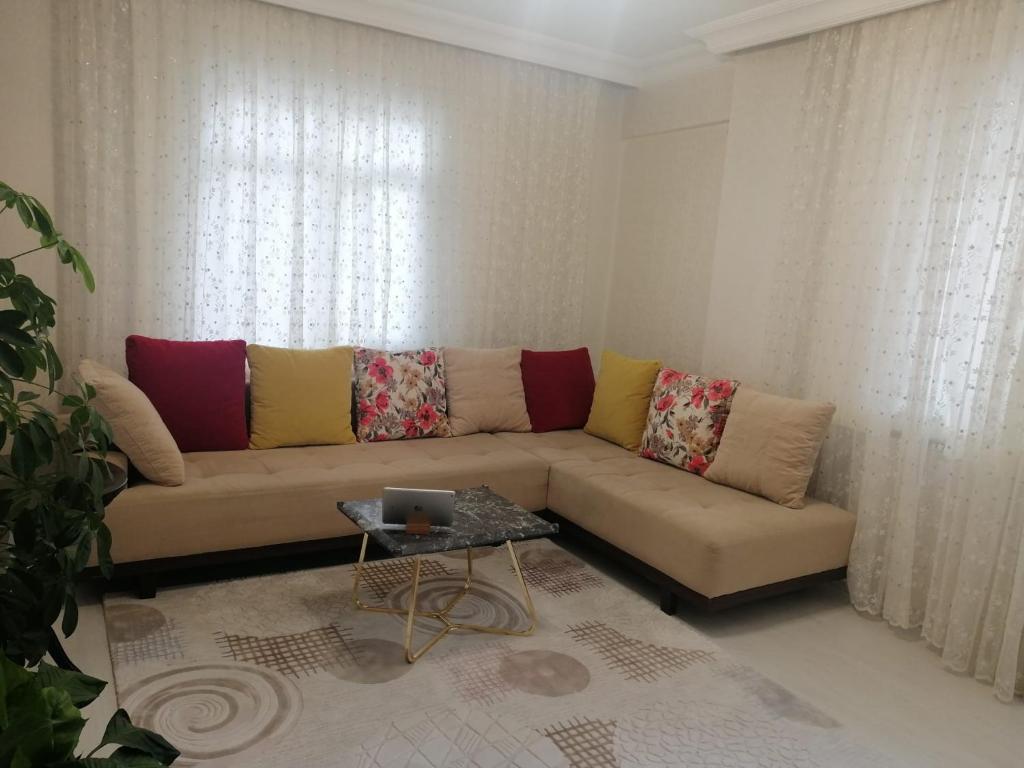 ein Wohnzimmer mit einem Sofa und einem Tisch in der Unterkunft Rahat ve sakin ev in Istanbul