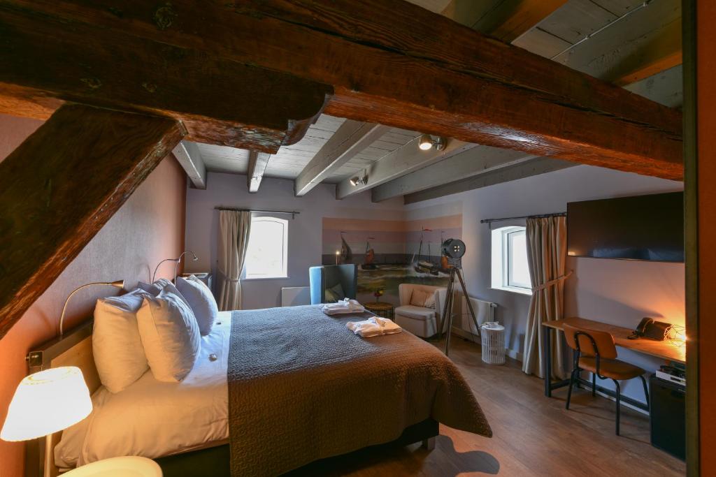 Postel nebo postele na pokoji v ubytování Hotel De Gravin
