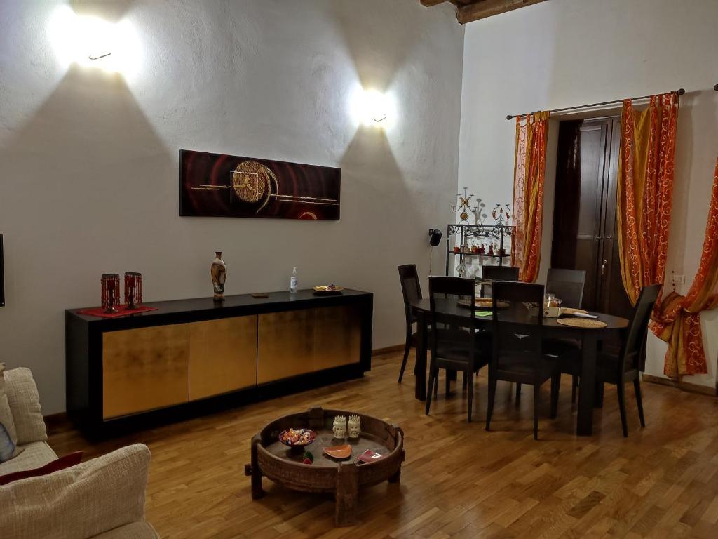 a living room with a table and a dining room at CASA MIKY in Palermo