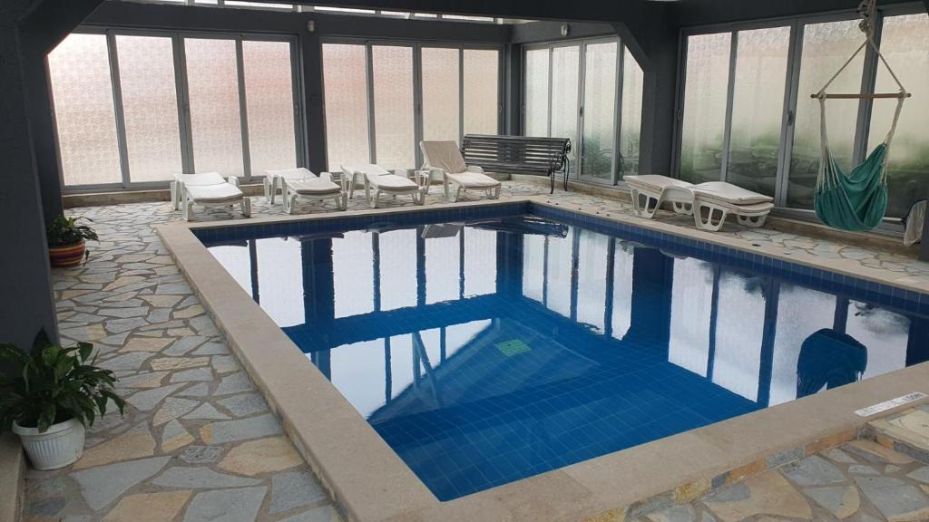 a large swimming pool with chairs at Holiday Home Bogumila in Risan