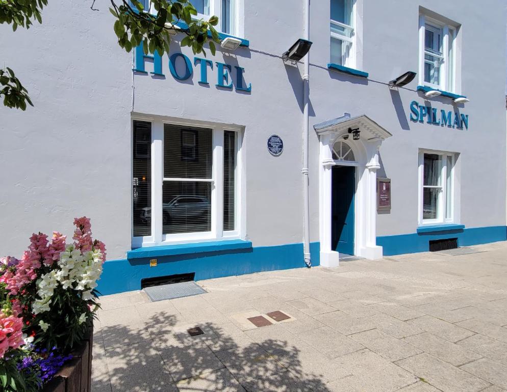 a hotel with a blue and white building at Spilman Hotel in Carmarthen