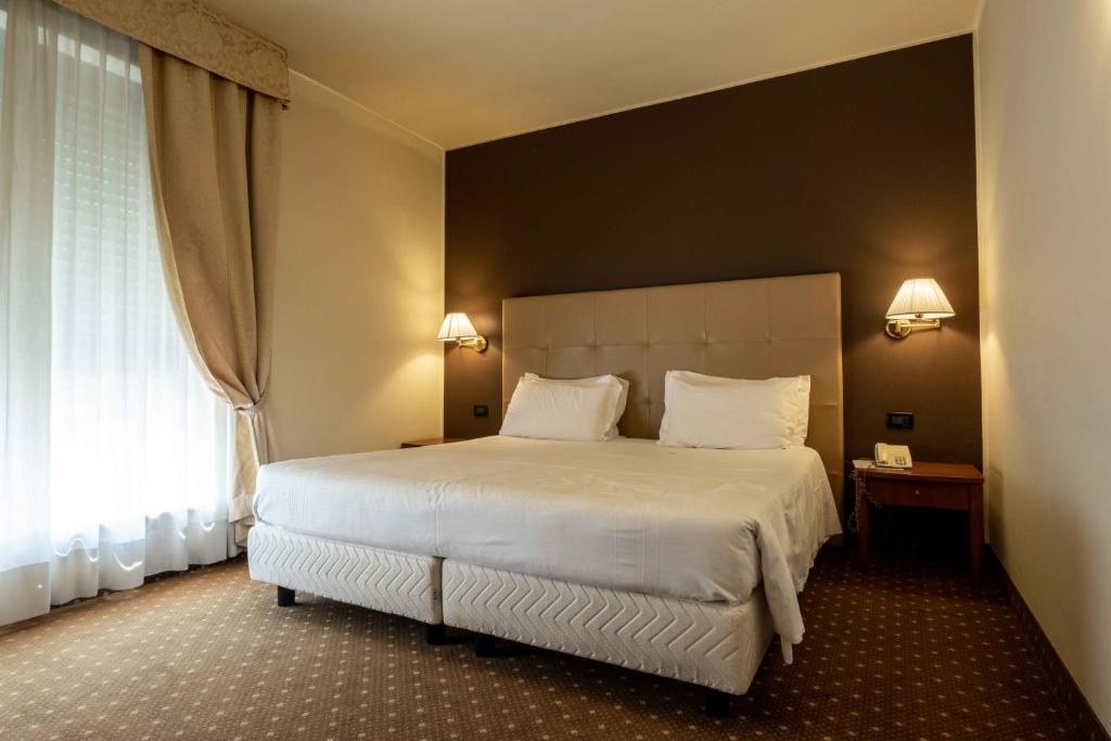 Postel nebo postele na pokoji v ubytování La Pieve Hotel