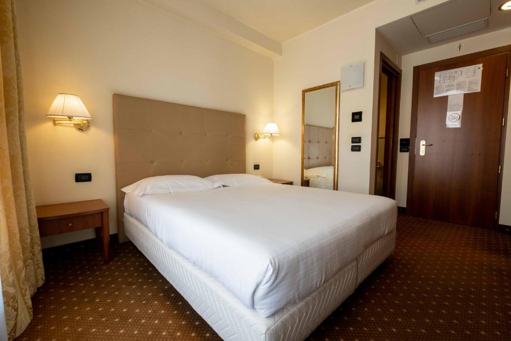 Postel nebo postele na pokoji v ubytování La Pieve Hotel