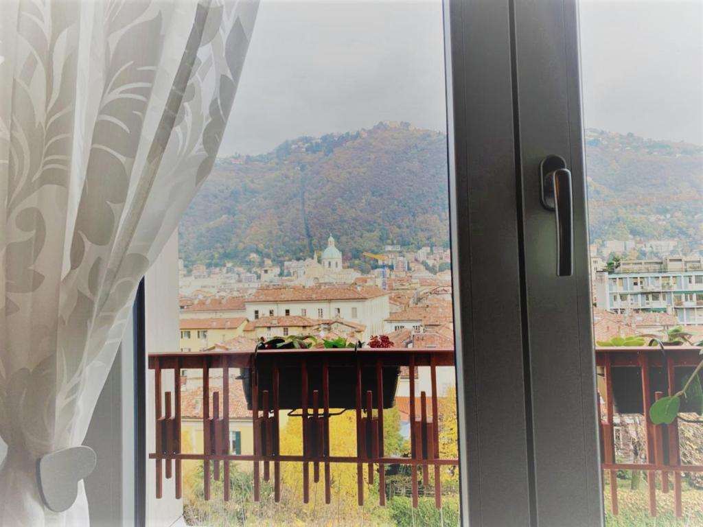a window with a view of a city at Maison 53 Incantevole appartamento vista Cattedrale di Como in Como