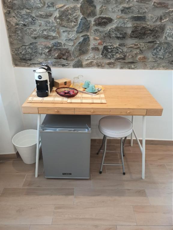 a wooden table with two stools and a table with a toaster at Affittacamere Albarola in Riomaggiore