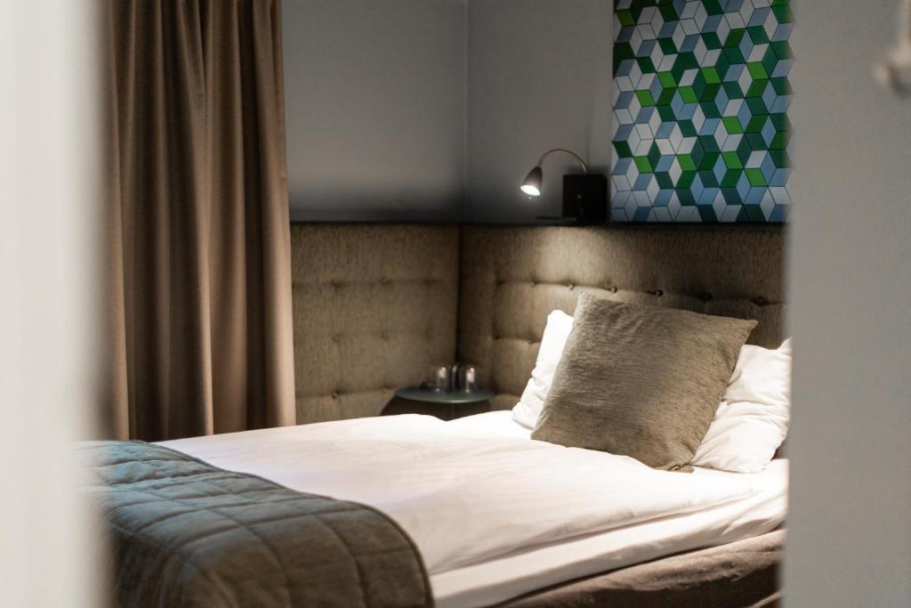 Postel nebo postele na pokoji v ubytování Hotel Poseidon