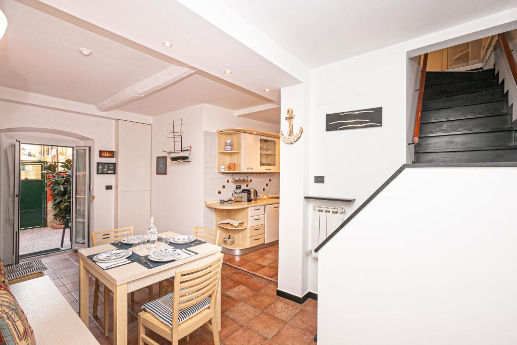 a kitchen and dining room with a table and chairs at CoZy House Boccadasse by the sea in Genova in Genova