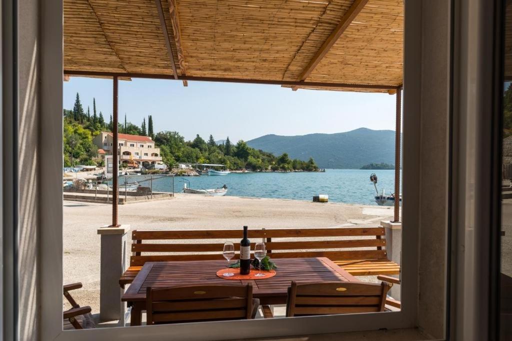 a table with two chairs and a view of a beach at Holiday Home Anima Maris in Ston