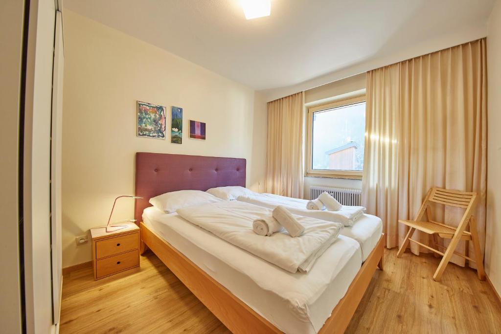 a bedroom with a large bed and a window at Appartement Delight in Saalbach Hinterglemm