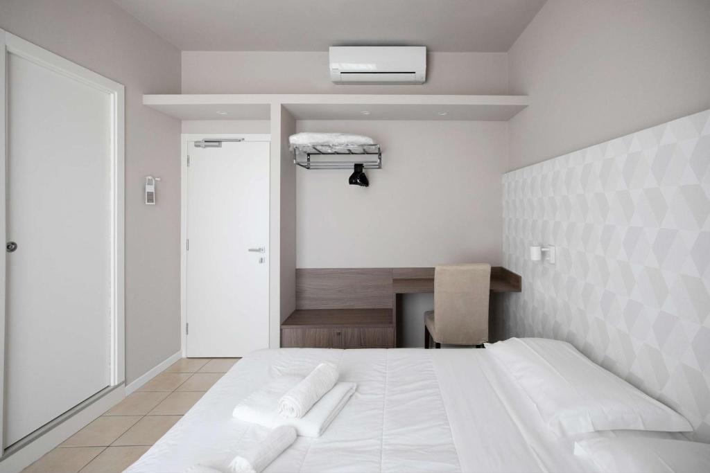 Postel nebo postele na pokoji v ubytování Hotel Benvenuto