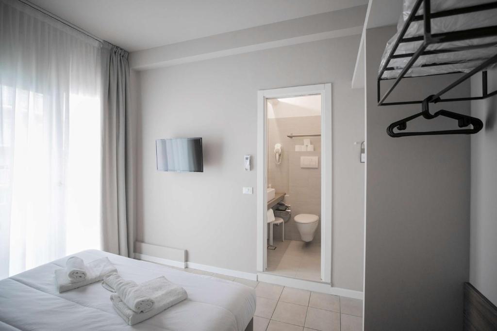 Postel nebo postele na pokoji v ubytování Hotel Benvenuto