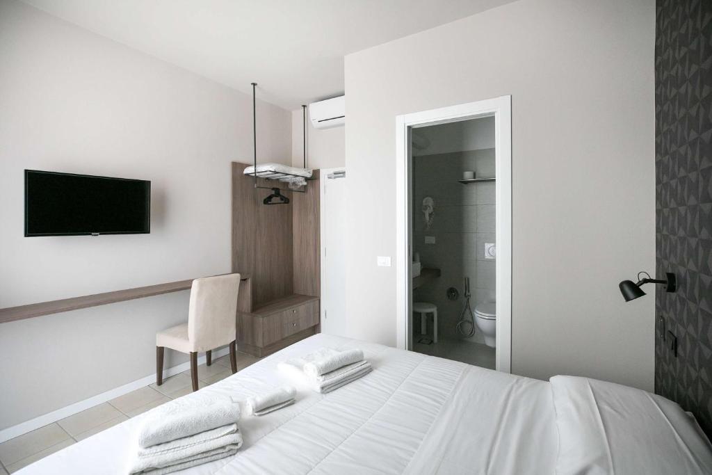 Postel nebo postele na pokoji v ubytování Hotel Benvenuto