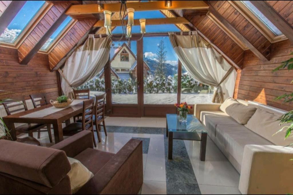 a living room with a couch and a table at Apartamenty Bella Vista in Zakopane