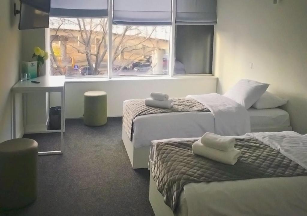 Ένα ή περισσότερα κρεβάτια σε δωμάτιο στο Kyivpasservis Hotel