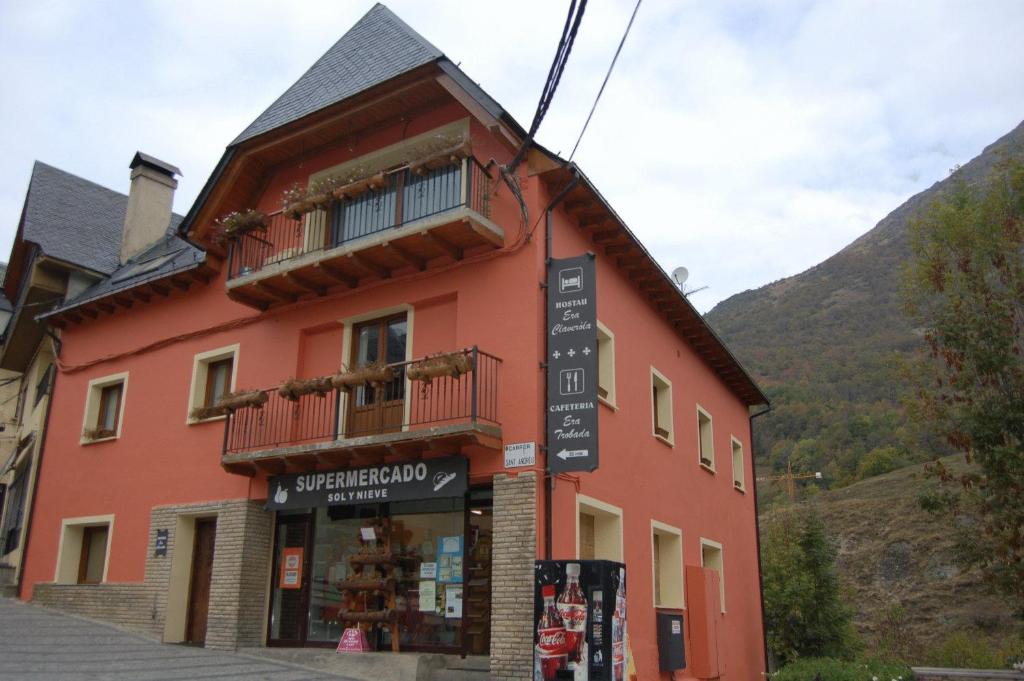 a building with a store in front of a mountain at Hostau Era Claverola in Salardú