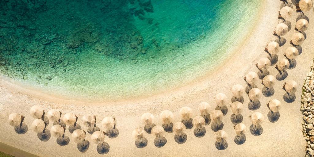 an aerial view of a beach with umbrellas at Aminess Vival Maestral Hotel in Novigrad Istria