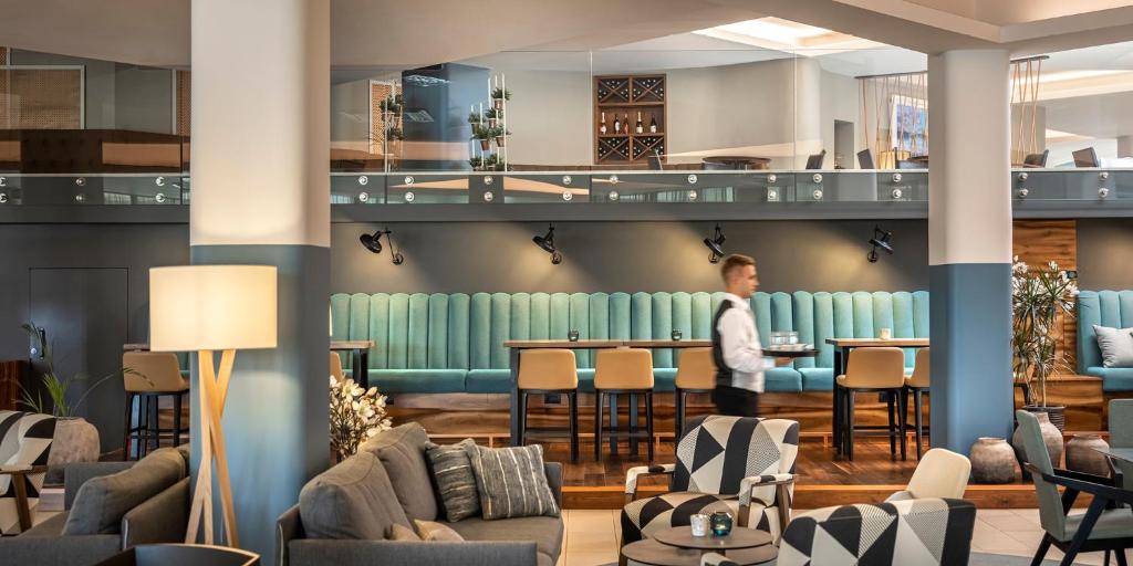 a lobby with a person standing at a bar at Aminess Vival Maestral Hotel in Novigrad Istria