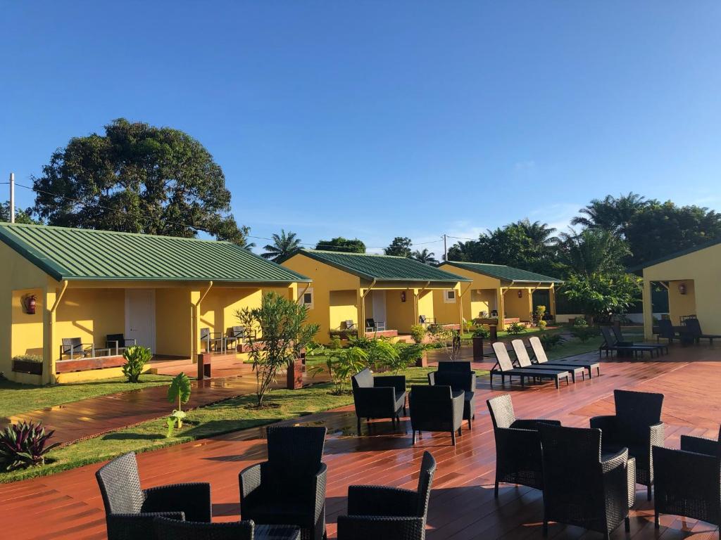 a row of houses with chairs and tables at Quinta Santa Rita - Príncipe in Cascalheira