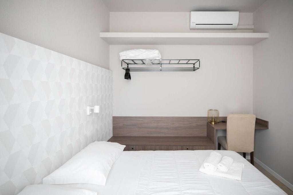 Postel nebo postele na pokoji v ubytování Hotel Benvenuto