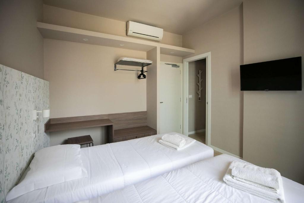 Postel nebo postele na pokoji v ubytování Hotel Benvenuto