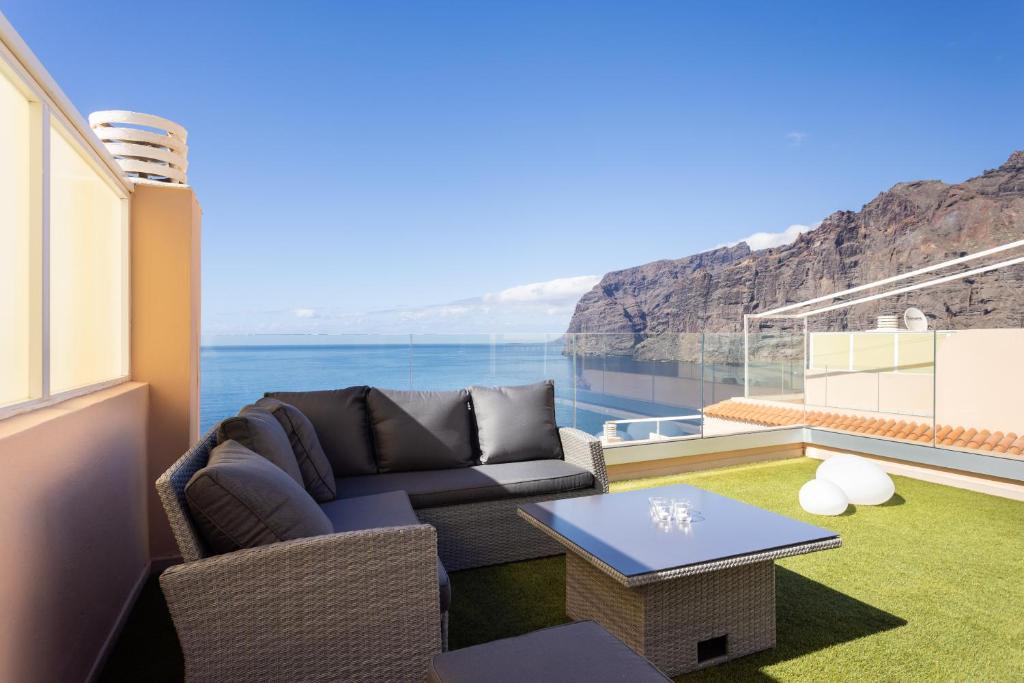 a living room with a couch and a table at SPECTACULAR PENTHOUSE WITH AMAZING VIEWS in Santiago del Teide